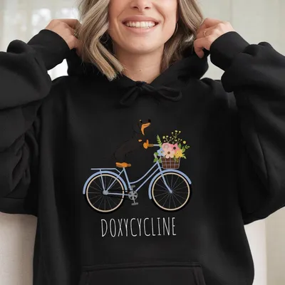 Doxycycline Pharmacy Pun Hoodie, Dachshund On Bicycle, Unisex Graphic For Pharmacists And Technicians