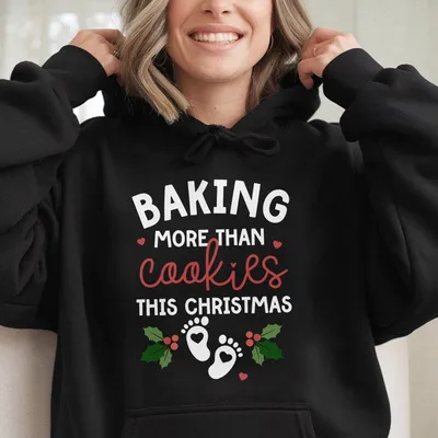 Baking More Than Cookies This Christmas Hoodie Fun Holiday Pregnancy Reveal With Baby Footprints And Festive Holly