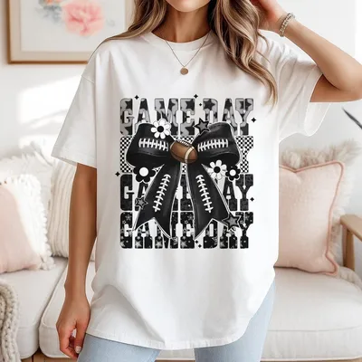 Gameday Football T-Shirt Trendy Black Bow With Mini Football Star Accents Perfect For Tailgate Parties Sports Fans